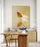 Gold butterfly framed print hanging above a wooden desk, natural light decor scene