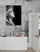 Framed Apollo poster (Greek god of the arts) against a raw concrete wall, pairing classical sculpture with modern industrial design