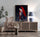 Framed wall art on a rattan sideboard with a wicker chair, geometric accent wall, and contemporary lamp for boho, natural decor