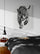 Modern master bedroom decor with double bed, black bedding, wall-mounted nightstand, white walls, wood flooring, and black & white animal wall art
