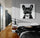 Master bedroom with large double bed, black bedding, wall-mounted nightstand, large pet wall art poster
