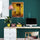 Yellow vintage bicycle wall art in a modern office with a green wall and a light wood desk
