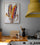 Colorful corn canvas art on a gray kitchen wall with a yellow range hood