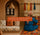 Authentic Moroccan interior with terracotta walls, Berber wool cushions with geometric patterns, traditional pottery, and an Amazigh woman weaving a colorful rug on a loom. Inspirational quote about Amazigh art overlayed.