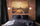 Industrial bedroom decor with large airplane sunset wall art on exposed brick walls