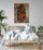 Adult bedroom with rattan bed, white bedding, green plants, light gray wall, Islamic calligraphy poster