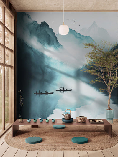 Japanese-inspired living room with wall art of misty mountain landscapes and boats on a lake. The space features a wooden coffee table, round turquoise cushions, a woven rug, and a tea set, creating a zen and peaceful ambiance for meditation or a tea ceremony.