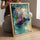 Textured turquoise, purple, and beige abstract canvas in a bright modern living room