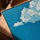 Minimalist office wall art with blue sky and ocean clouds