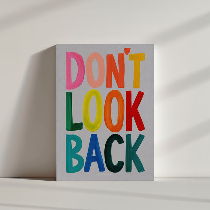 Colorful Don't Look Back typography canvas in bright minimalist office interior