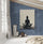 Canvas wall art adding a meditative, calming touch to a bedroom with textured blue walls