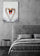 Framed poster of two swans forming a heart in a gray minimalist bedroom