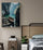 Bedroom wall art: painting of a boat on a peaceful lake hung above a nightstand