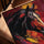 Red, yellow and black abstract horse impasto painting in a golden oak frame on a modern table