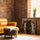 Tableau chevaux ornés motifs tribaux plumes bohème salon mur brique fauteuil cuir camel