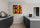 Colorful pop art wall art of Coca‑Cola bottles in a modern minimalist kitchen