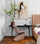 Abstract equestrian wall art enhancing a modern office with exposed brick walls