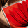 Red flower canvas with coral backdrop in modern living room, oak frame