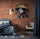 Bedroom with brick wall featuring colorful Japanese street art canvas