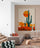 Large cactus wall art in a modern minimalist living room with gray sofa and boho accents