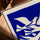 Klein blue canvas with white doves in oak frame displayed on a table
