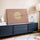 Zen birds in flight with a golden moon, blush pink canvas hung above a modern living room sideboard