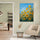 Yellow sunflower painting on a vivid blue background in a modern minimalist living room, floral wall art