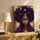 Black and gold goddess canvas wall art for living room decor, shown above an oak sideboard with a lamp