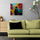 Small canvas painting of a colorful alley with a lone street vendor in a working-class neighborhood, hung in a living room