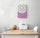 Colorful kitchen wall art on a white wall with vibrant purple and white tones, above a wooden table with two white chairs, bread basket and small melon for a fresh, harmonious dining look