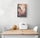 Vintage 1950s-style Paris wall art in soft pink and gray showing a Parisian street with the Eiffel Tower in the background, above a white table and two chairs