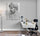 Bright modern home office with glossy white desk and decor; light gray wall displays a monochrome The Thinker poster
