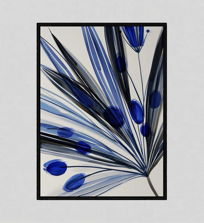 Framed wall art depicting an abstract flower with blue and black petals on a white background in a thin black frame. The illustration combines graphic elegance and modern botanical style.