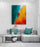 Modern living room with light gray sectional, turquoise cushions, coffee table, and coastal boat wall art