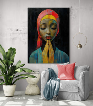 Large canvas of African woman on a gray wall, big white armchair with pink cushion. Lush green plant and concrete table creating a tropical and gentle ambiance.