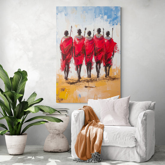 African-inspired wall art featuring five Maasai warriors walking away, showcased in a minimalist living room with a white chair, camel throw, and tropical plant.