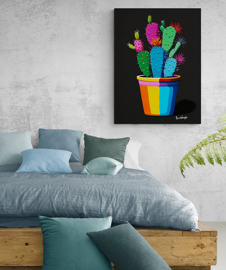 Ambiance cosy sublimée par notre tableau cactus, injectant une touche artistique colorée à la chambre.
