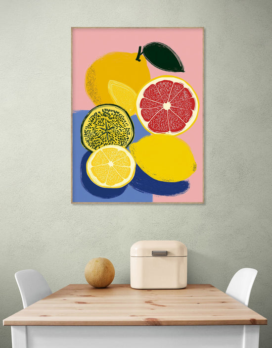 Fruity wall art with lemons and grapefruit on a pink background, modern kitchen vibe