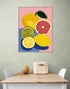 Fruity wall art with lemons and grapefruit on a pink background, modern kitchen vibe