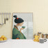 Cozy kitchen corner with Japanese geisha wall art in a green kimono holding a teacup, by a window on a wooden countertop