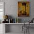 Vintage yellow bicycle artwork hanging above a gray wall-mounted desk with a metal chair. ALT 2: Retro wall decor featuring a yellow bicycle in a stylish and elegant workspace.