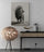 Modern living room decor with black and white lion poster, gold accents and floor lamp