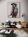 Colorful gladiator wall art hanging above a black bookcase