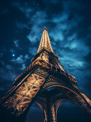 Photograph of The Eiffel Tower majestically standing under a starry sky, bathed in golden light contrasting with the bluish hues of the night.