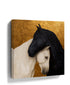 Black and white horses canvas wall art with gold accents in room setting