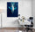 Modern white desk with metal legs, rolling chair, blue cushion, floor lamp, white wall with blue whale poster