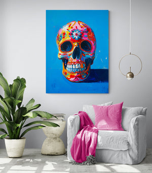 Living room with comfy chair, pink cushion and throw, modern white side table, large green plant, bright room, hanging light, light gray wall, skull artwork.
