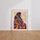 Poster Femme afghane - Regard voyageur aux couleurs vives — Vierge - living-room — passe-partout blanc