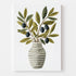 Print featuring a striped vase adorned with olive branches, showcased in a kitchen decorated with modern and natural elements (plants, metal carafe, fruits). The overall feel is fresh and authentic.