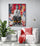 pièce de vie, fauteuil blanc confortable, coussin et plaid rouge, table d'appoint moderne, grande plante verte, mur blanc, tableau street art